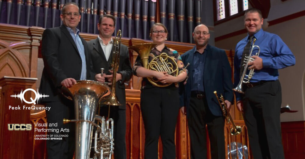 nexus brass holding their instruments in the transept of a church